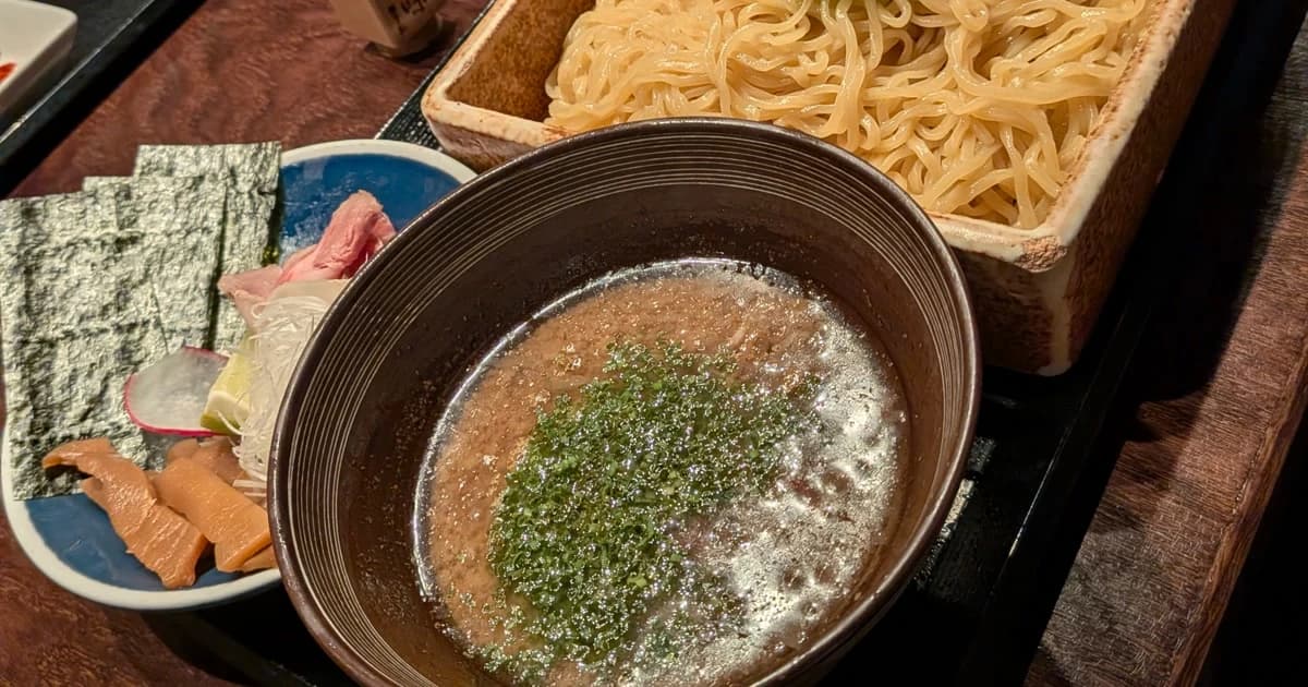 A bowl of tsukemen with thick noodles and dipping broth at Tabetomo